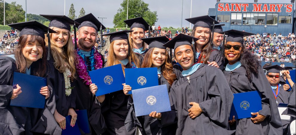 Graduate students hold their diplomas and celebrate at Saint Mary's 2023 Commencement