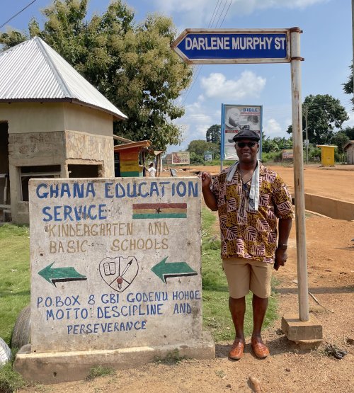 Father Kwame Assenyoh outside of a school in Ghana