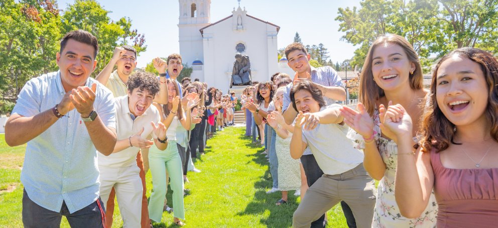 Happy students in front of the chapel