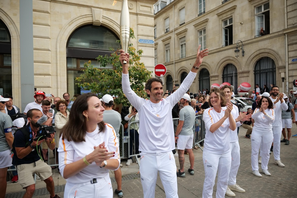 Romain Lachens holding Olympics torch for 2024 Paris games