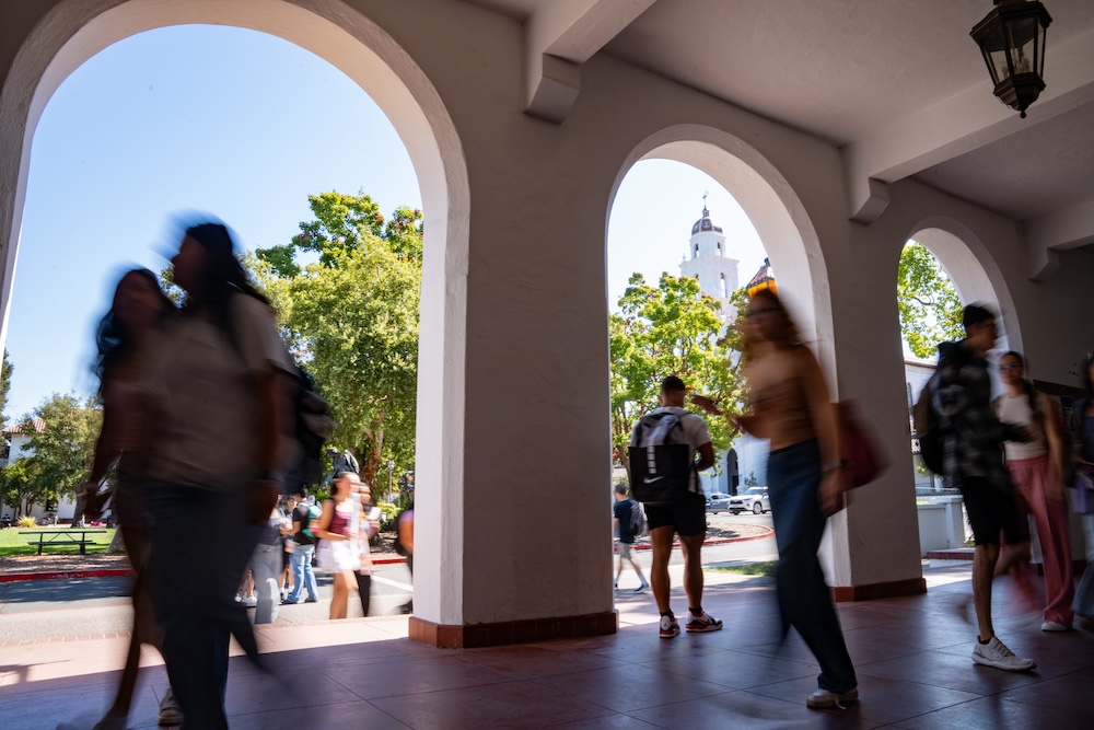 Students walking under the arcade on the first day of classes, August 2024