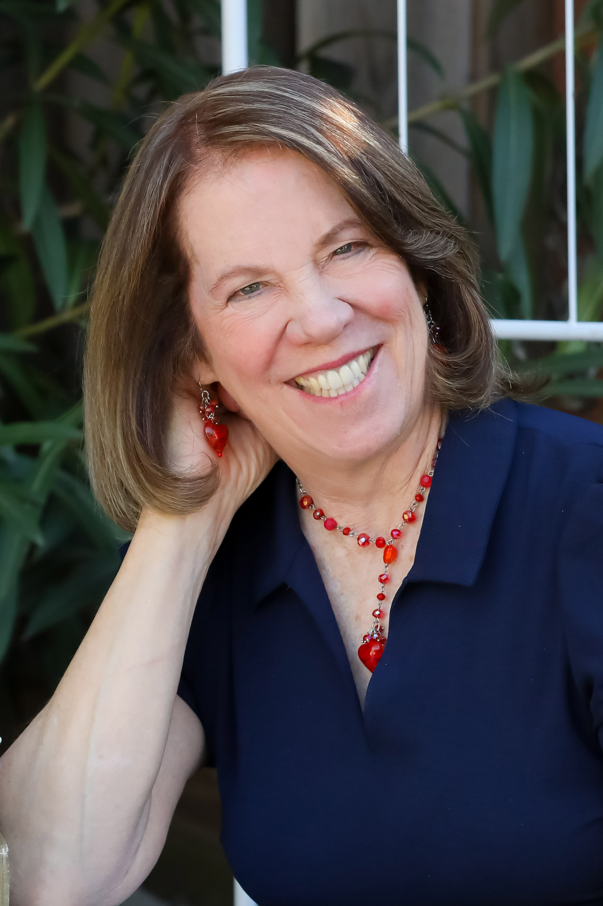 Headshot of Jenyth Gearhart-Utchen with plants in background