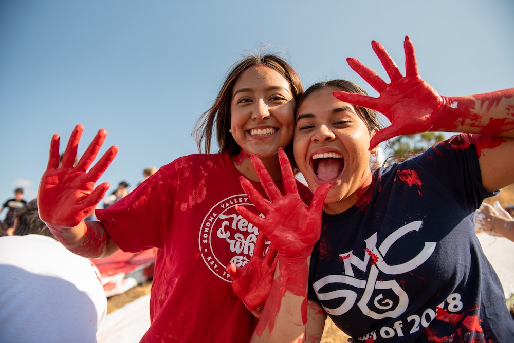 Two students show off paint on their hands after painting the SMC, August 2024