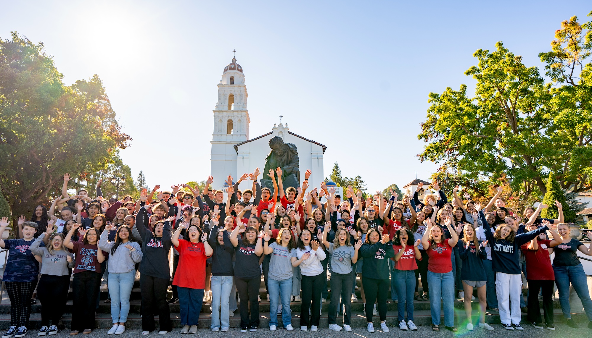 Weekend of Welcome volunteers (WOWies) in front of the chapel, August 2024