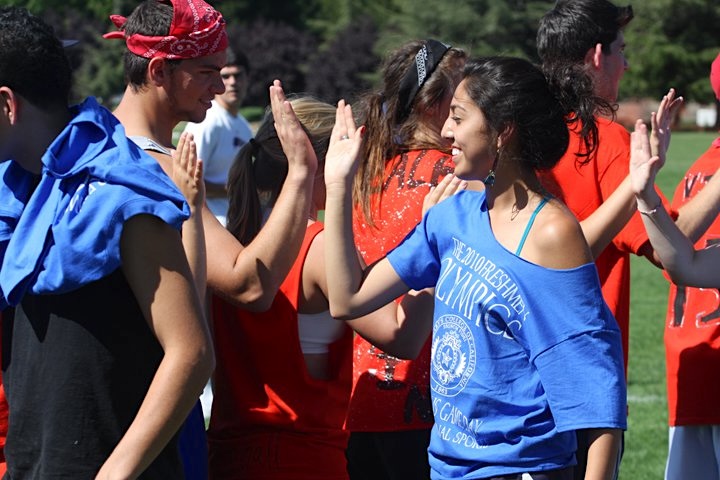 Students high-fiving at 2010 first year olympics