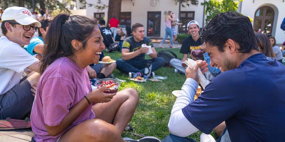 Students eating and smiling during orientation at Saint Mary's College