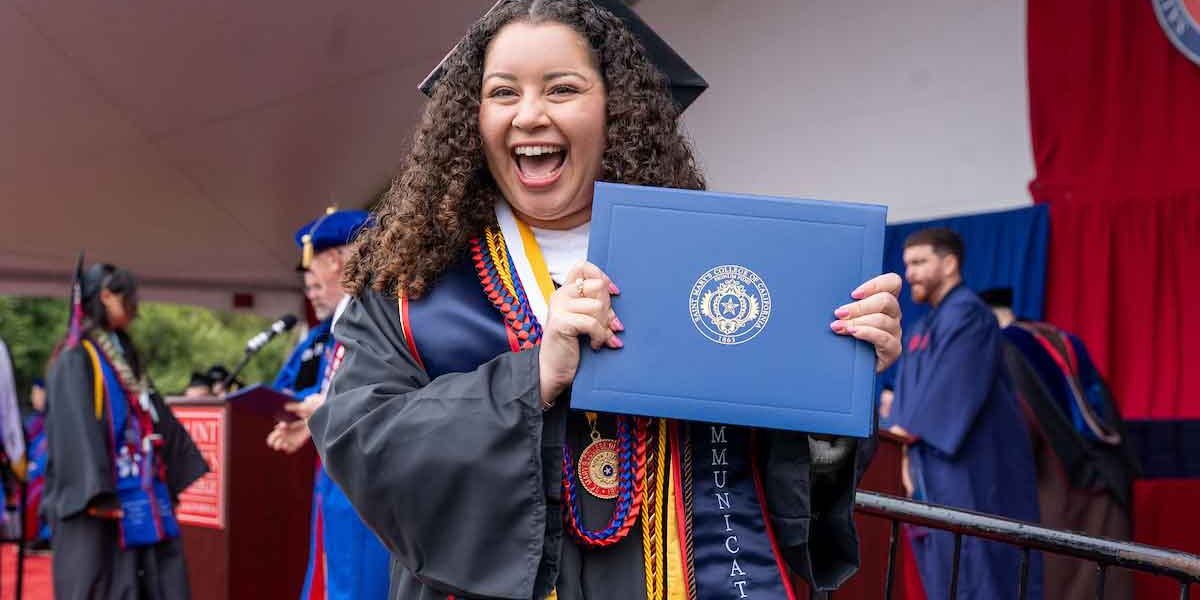 Saint mary's college graduate holding her diploma