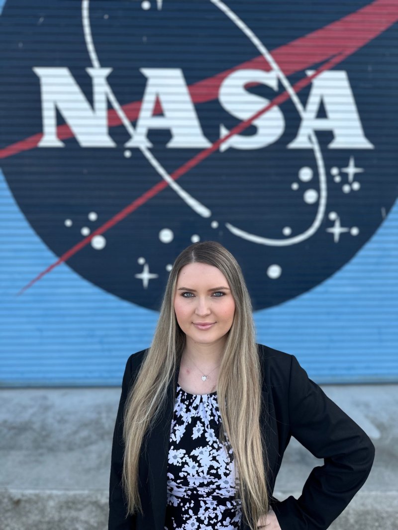 Emina Zancic in front of a NASA logo