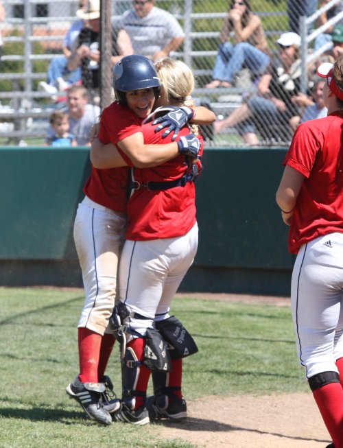 Players embrace after a home run.