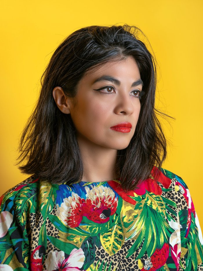 Headshot of Visiting Writer Ingrid Rojas Contreras on a yellow background.