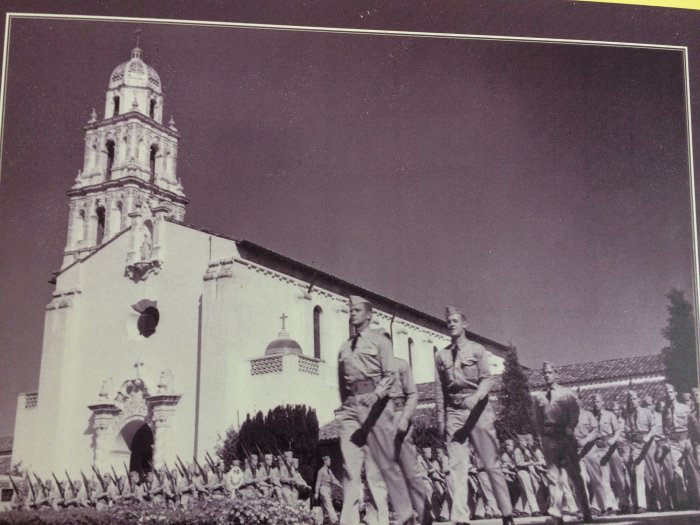 Black and white photo of military peronnel in formation in front of SMC Chapel