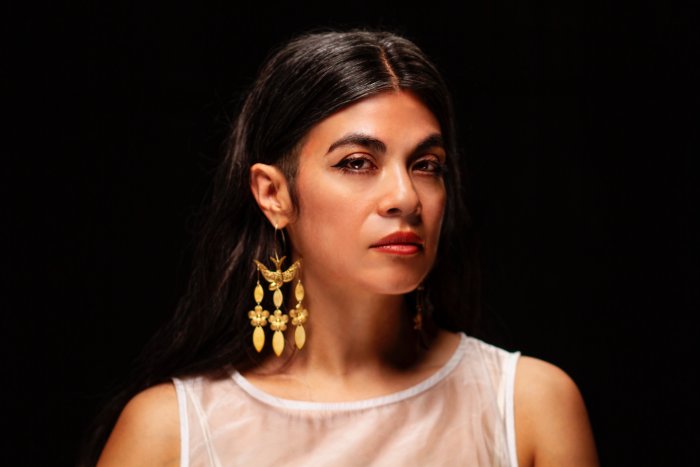 headshot of novelist and faculty member ingrid rojas contreras on a black background