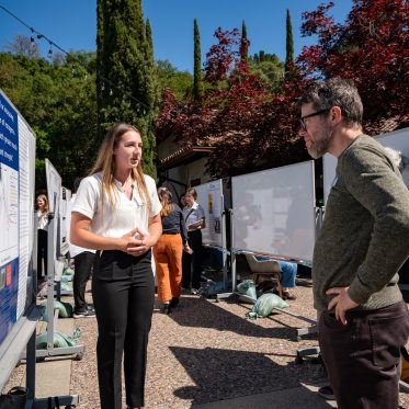 Student discussing their presentation with a Conference judge