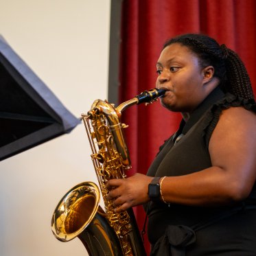 Student playing the saxophone at the 2024 Student Research Conference