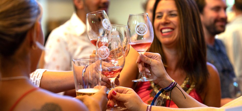 Five people cheersing wine glasses