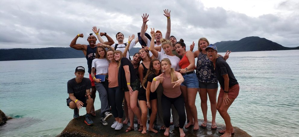 Students stnding on a small island/rock