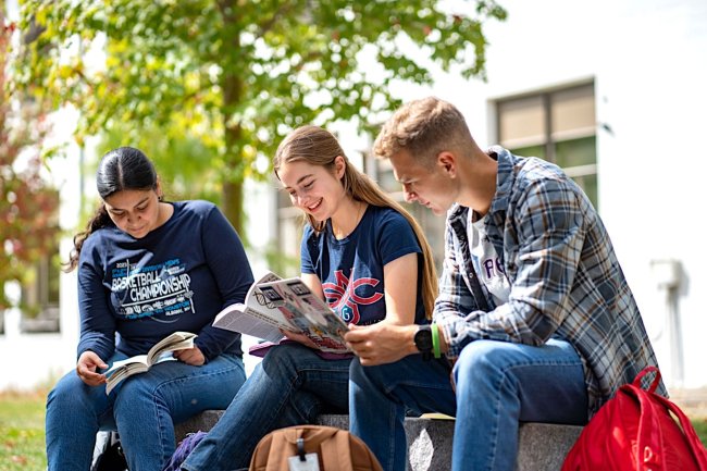 Students reading books together at the Saint Mary's College Summer Academy