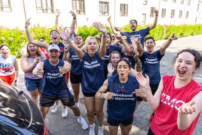 Students cheering wearing shirts that say Weekend of Welcome