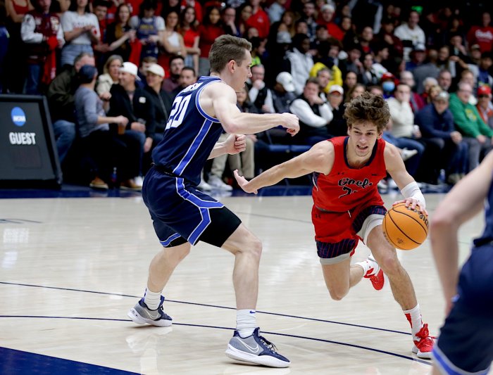 Basketball player Aiden Mahaney drives against BYU
