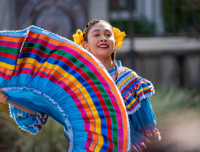 A student dancing at a Dia De Los Muertos event