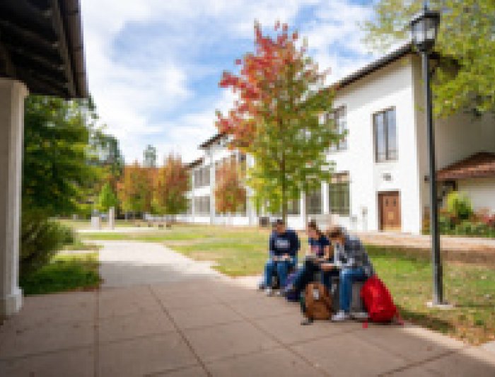 students sitting on a bench at SMC campus